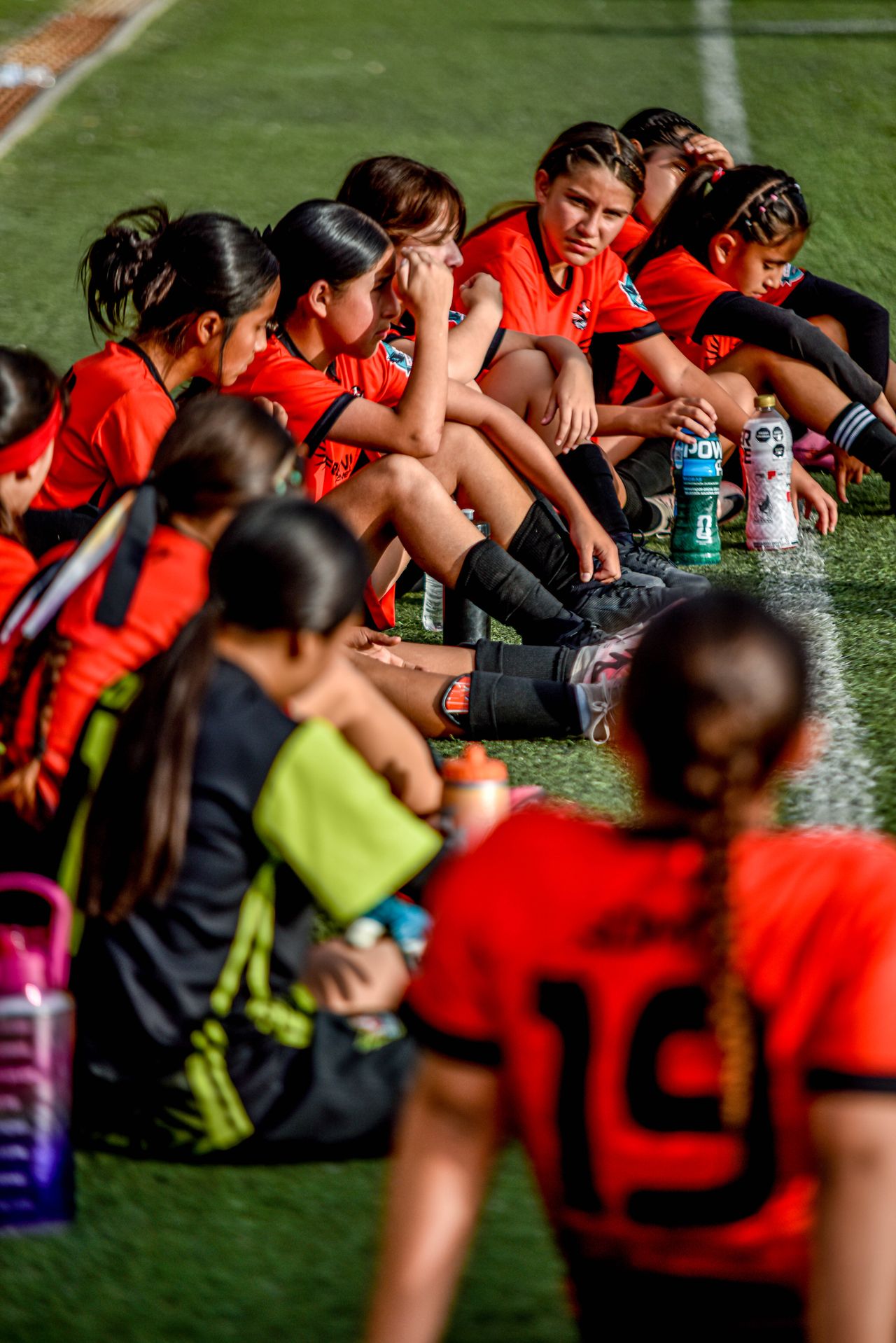 A youth soccer team listening at halftime